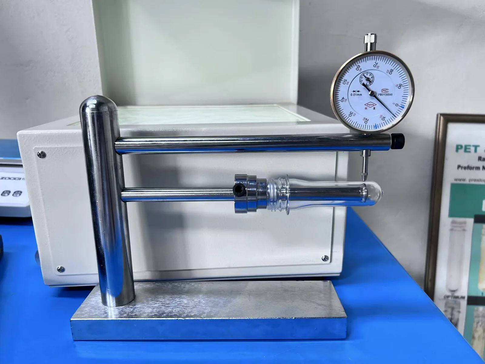 PET preform dimensional inspection with a dial gauge