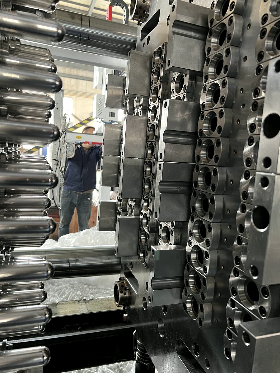 Open PET preform mold assembly detail in the workshop