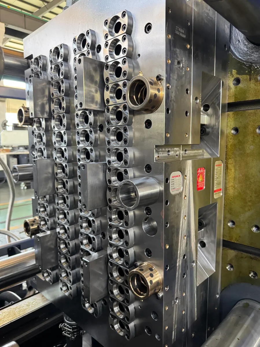 Real PET preform mold cavity side installed on an injection machine