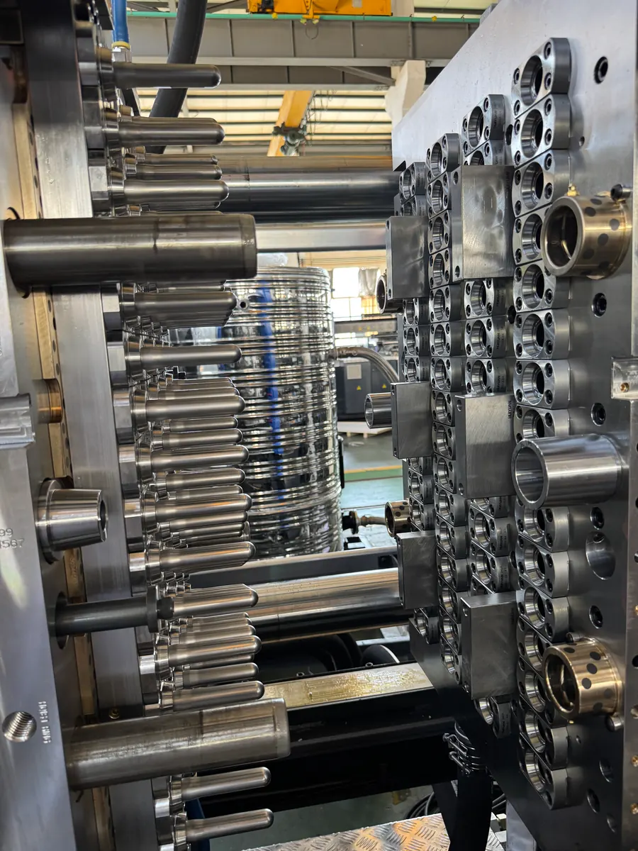 Real open PET preform mold assembly shown on the project contact page
